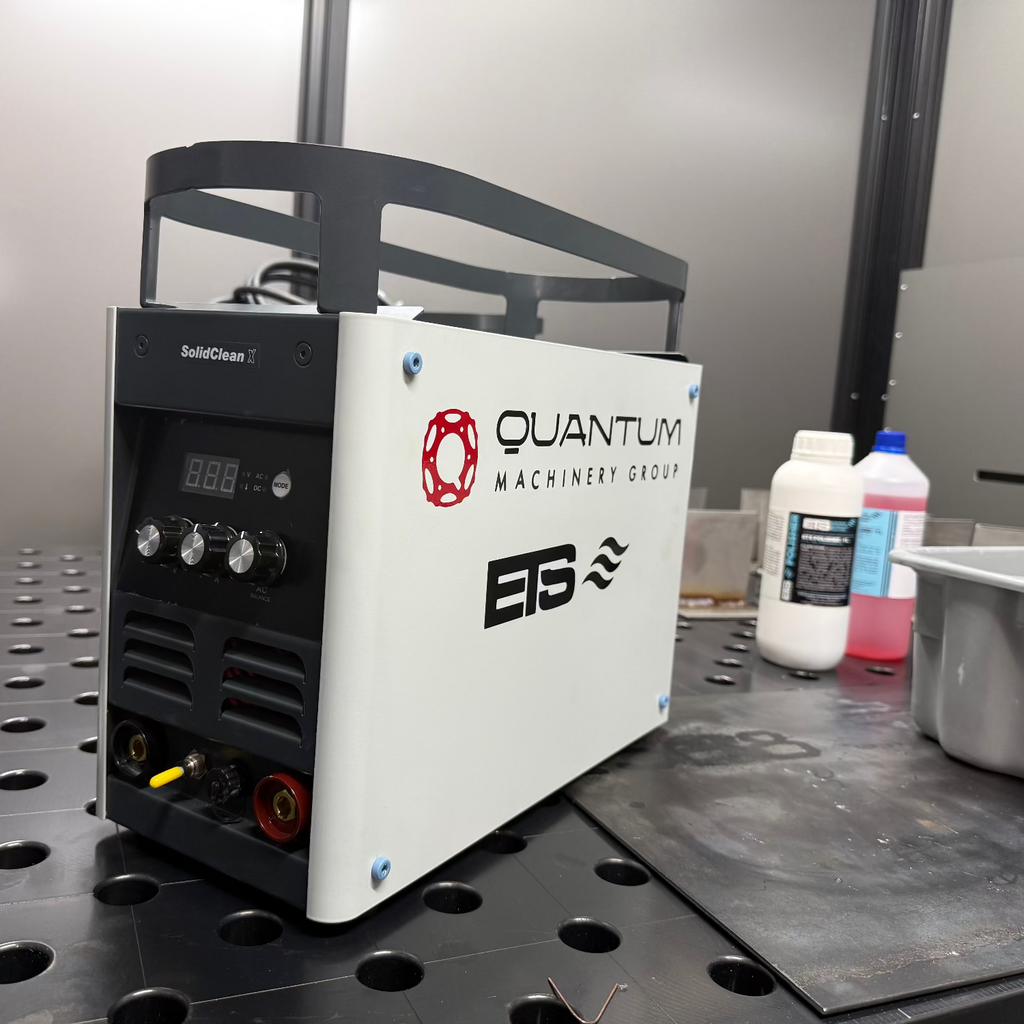 Quantum Machinery Group machine on a workshop table with various items around