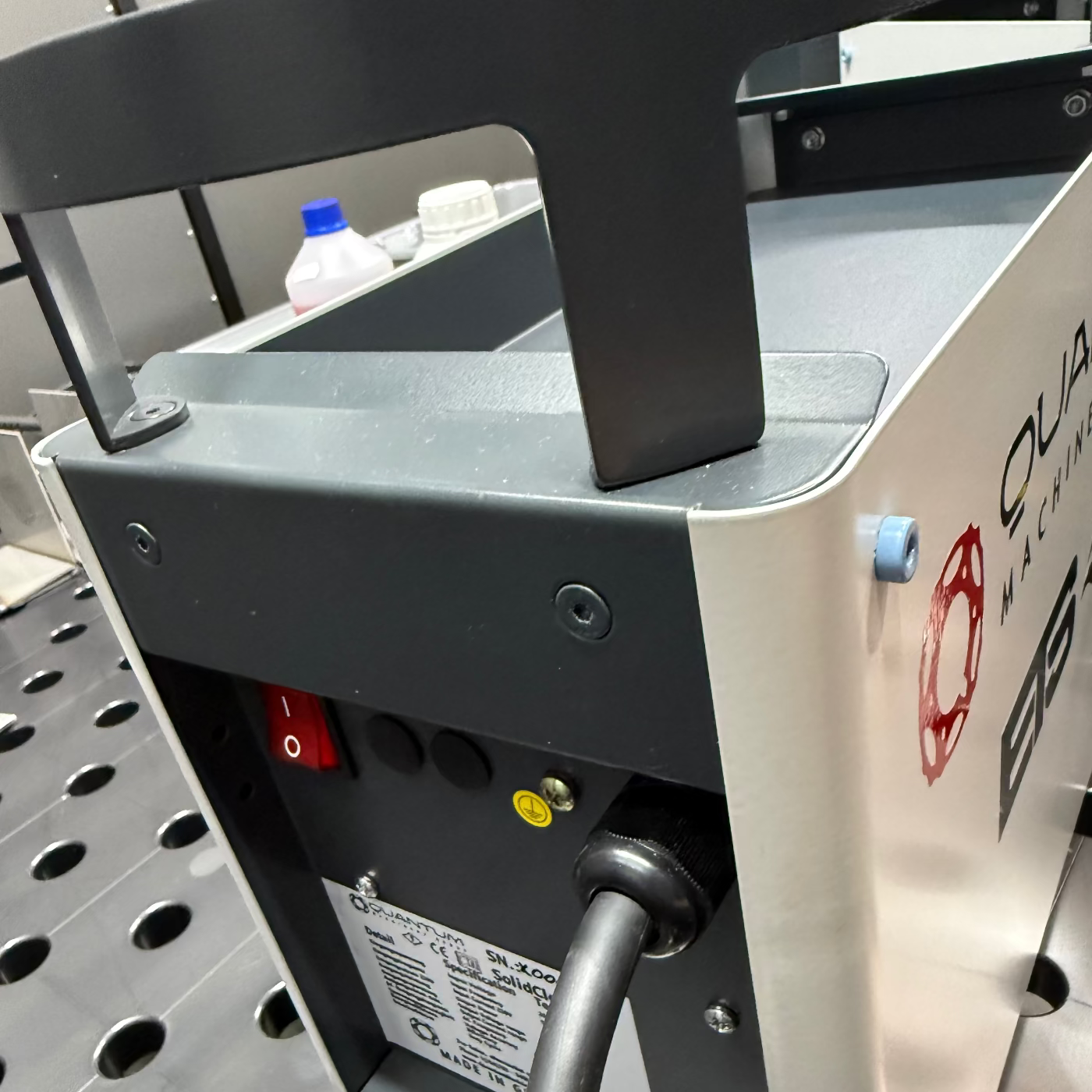 Close-up of a machine with visible branding on a metallic surface